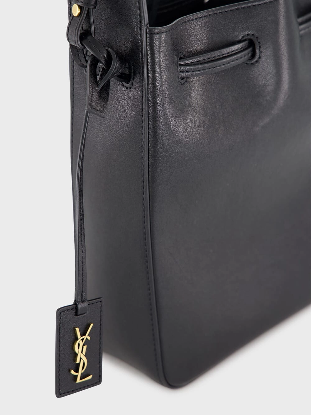 Black Leather Bucket Bag with Cassandre Charm