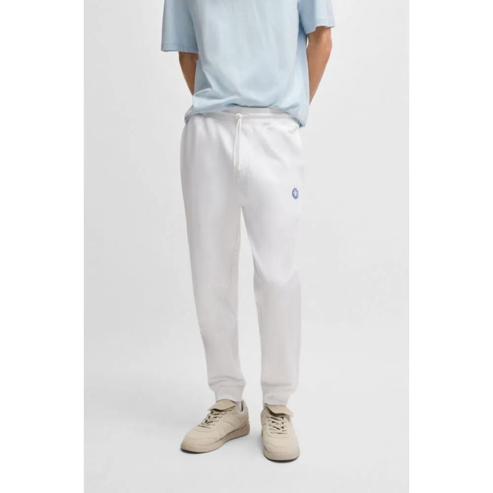 Cotton-terry tracksuit bottoms with Happy HUGO logo patch